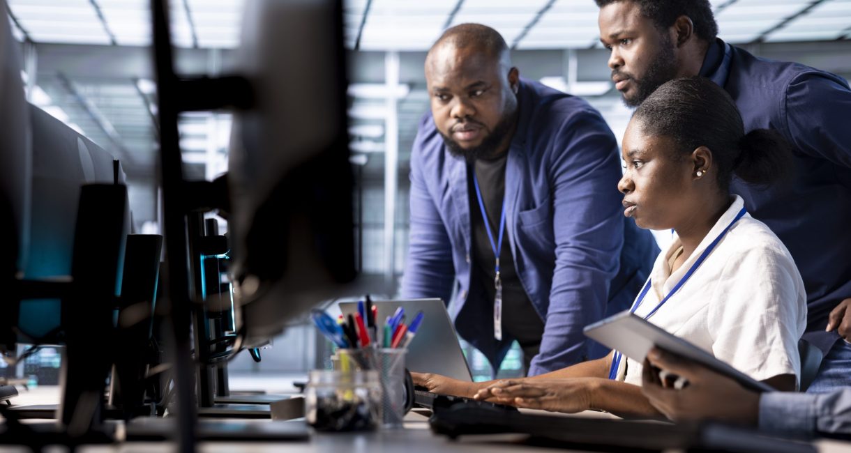 Team of data center office technicians using programming languages to construct algorithms and build applications. Server hub IT staff members debugging and optimizing code